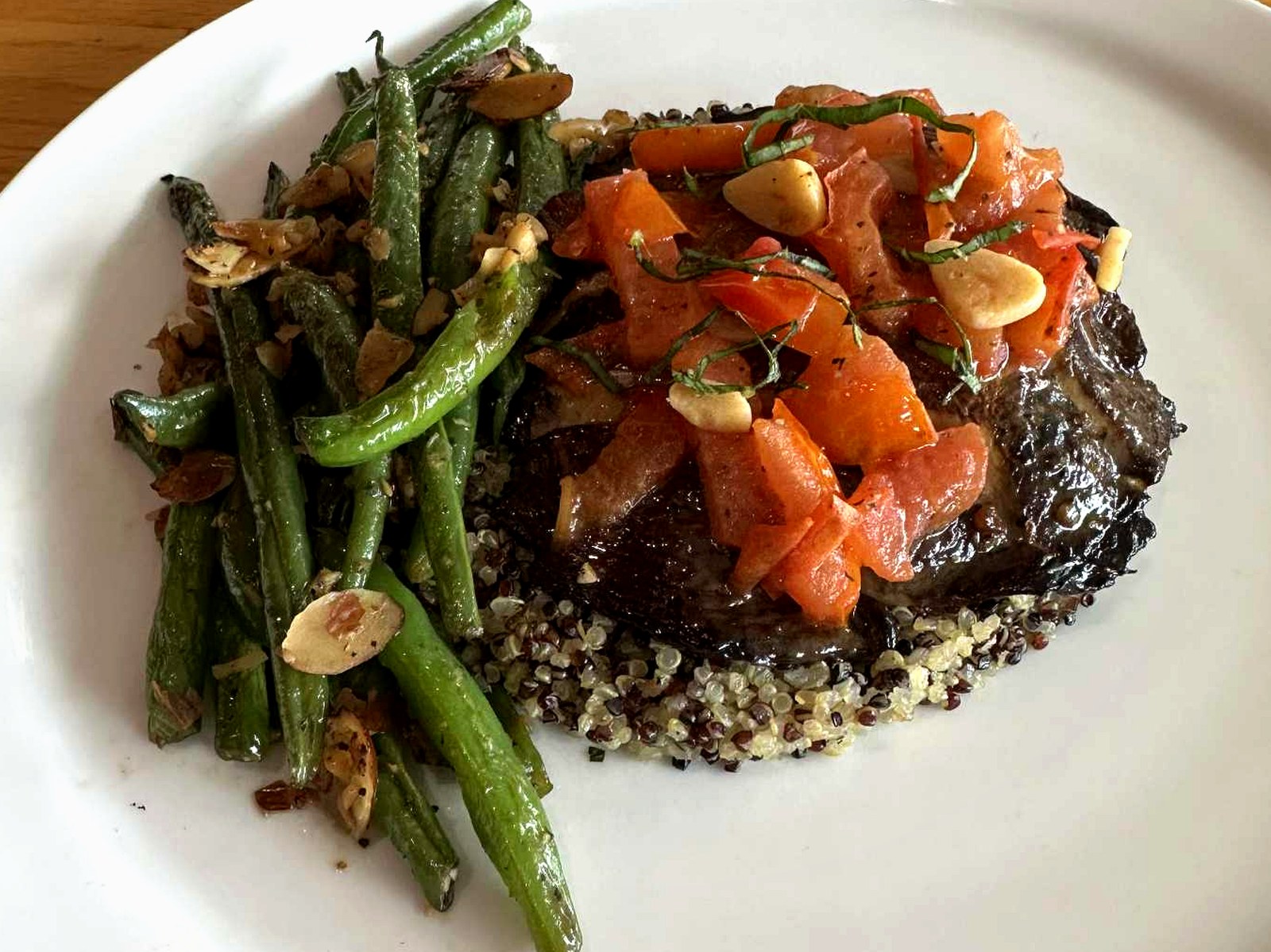 Roasted portobello on quinoa with tomato relish and green beans